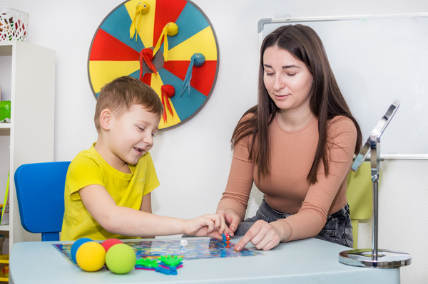 Young Woman Speech Therapist Is Engaged in the Office with a Child